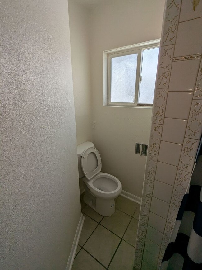 Building Photo - Ground Level 2 Bedroom, 2 Bath apartment. New flooring and paint. Tenant pays electric and natura...