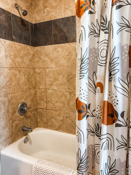 Tiled shower with full tub. - 819 Edmund Ave