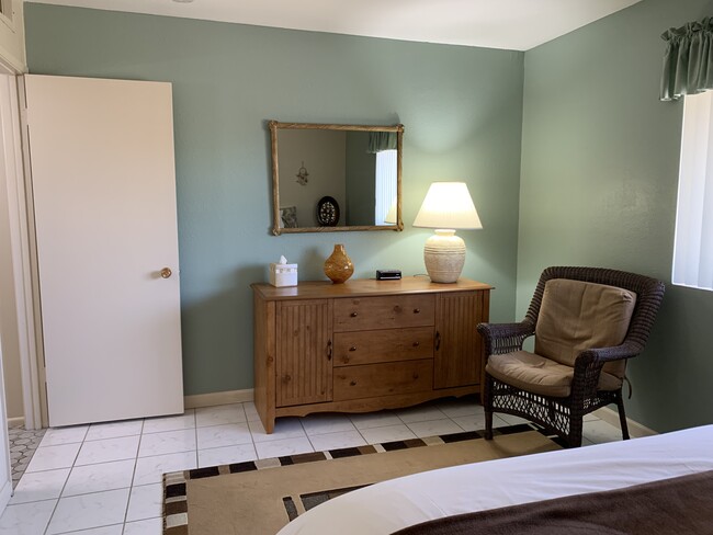 Guest bedroom has a queen-size bed, full-size dresser, 2 nightstands and a walk-in closet. - 10113 W Pebble Beach Dr