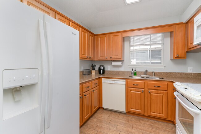 The kitchen has a granite countertop and is fully stocked with everything you need to cook at home. - 6464 Starfish Cv