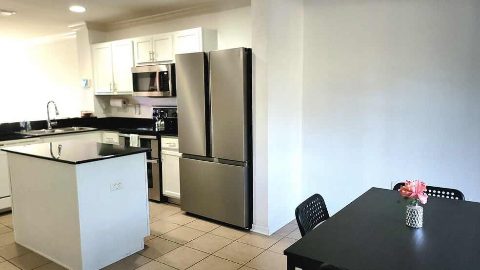 The kitchen is open to the living room and dining room for a perfect social setting. - 4408 Tuscan Loon Dr