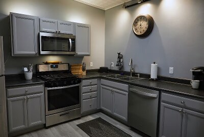 Updated kitchen with full-sized refrigerator, newer dishes, cutlery, glassware and more. - 9 May St