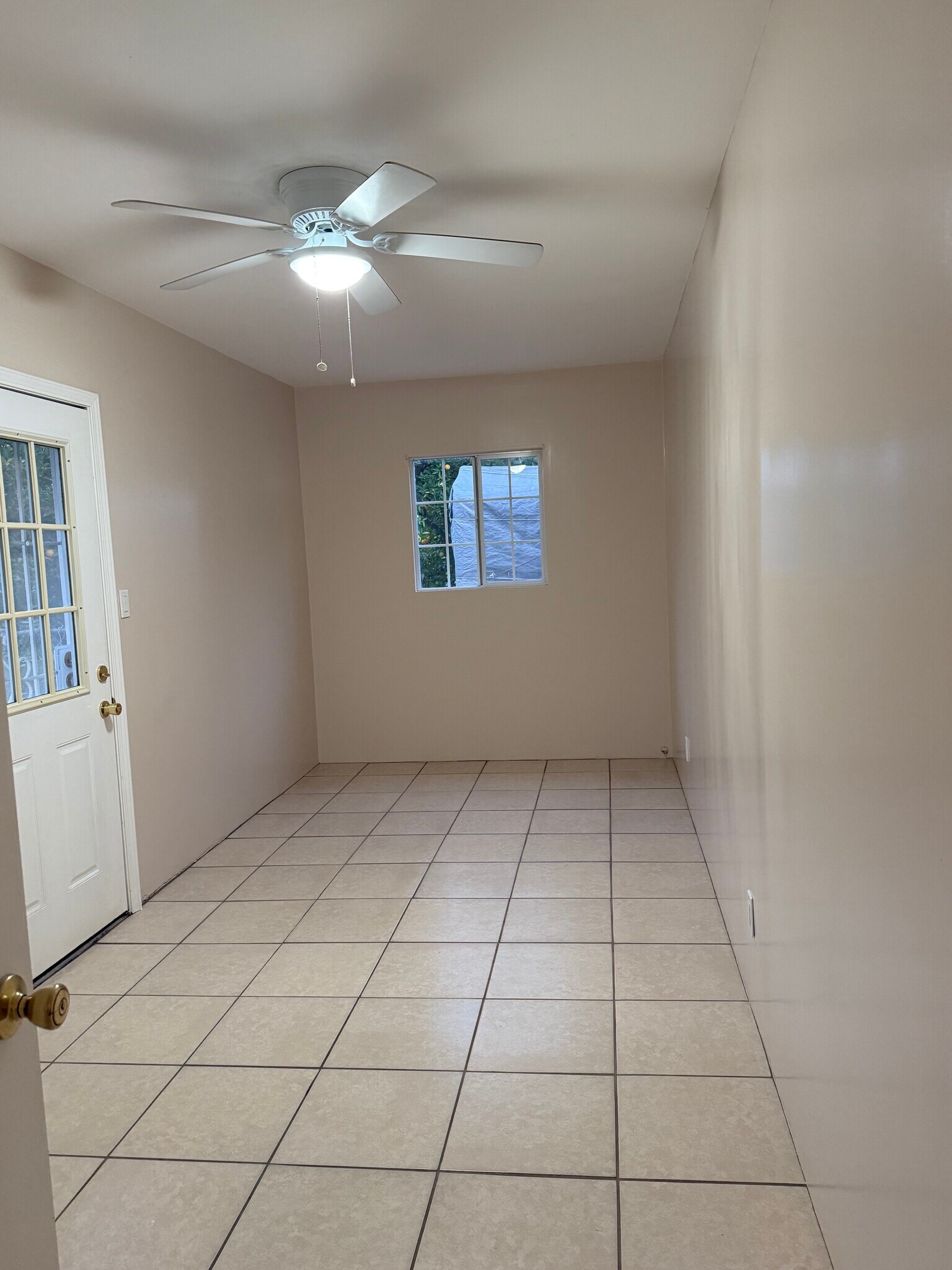 Bedroom from hallway. Back door with security screen door. - 17526 Horace St