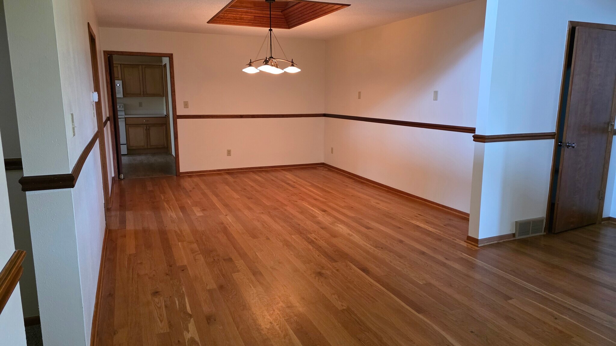 Dining room with wood floor, mirrored ceiling insert. - 620 East St S
