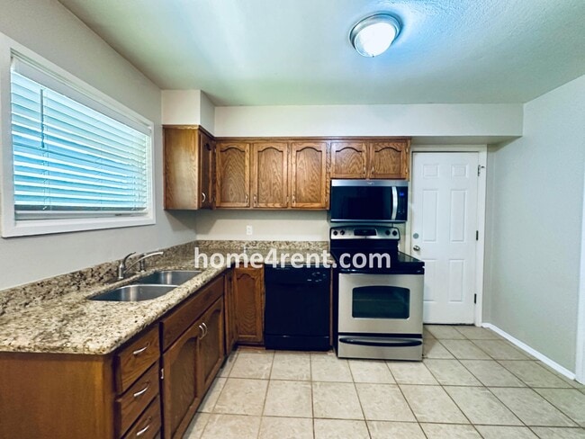 Building Photo - Attractive Prairie Village Ranch w/ FRESH PAINT, Wood Floors, Granite Counters and a Fenced Yard!