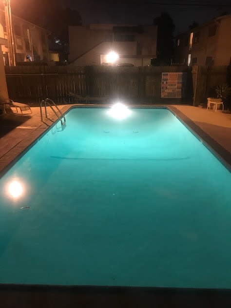 Crystal Clear Swimming Pool Aglow at Night - 2636 Kansas Ave