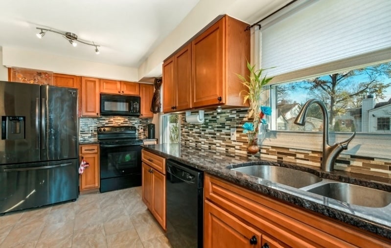 The kitchen offers a warm and inviting space designed for both everyday living and entertaining. - 237 Johnson Ave