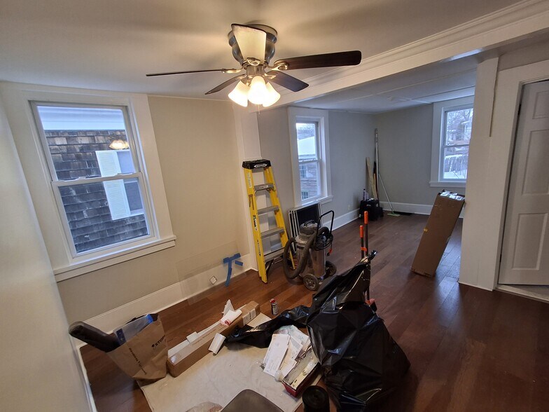Living Room: Ceiling fan, laminate flooring, and a closet (not in-frame). Excuse the mess! - 13 Mulberry St