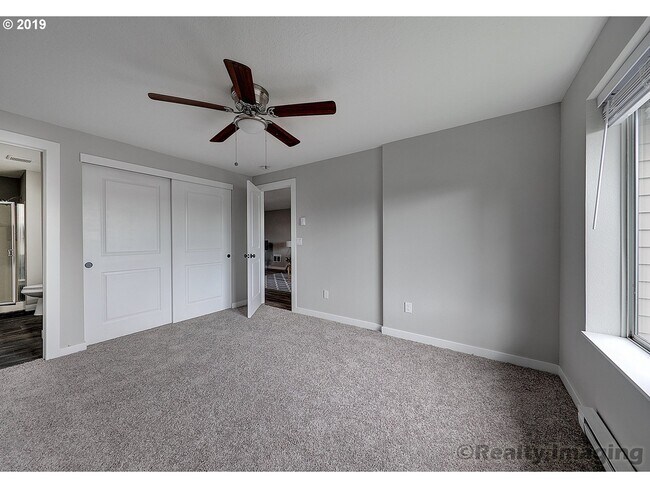 Master Bedroom with Ceiling Fan and Spacious Closet - 6150 SW Alice Ln