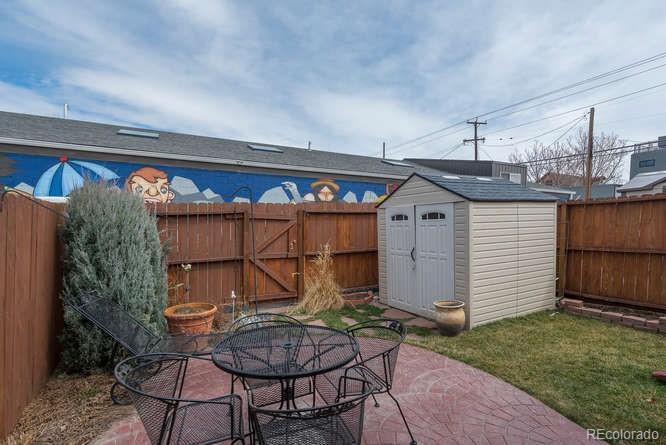 Great back yard with stamped concrete patio and storage shed. Back gate opens to reserved parking spot. - 1231 31st St