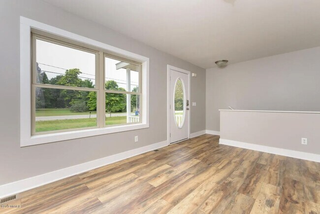 Building Photo - Spacious 3BR Duplex with Finished Basement & 2-Car Garage in Otsego