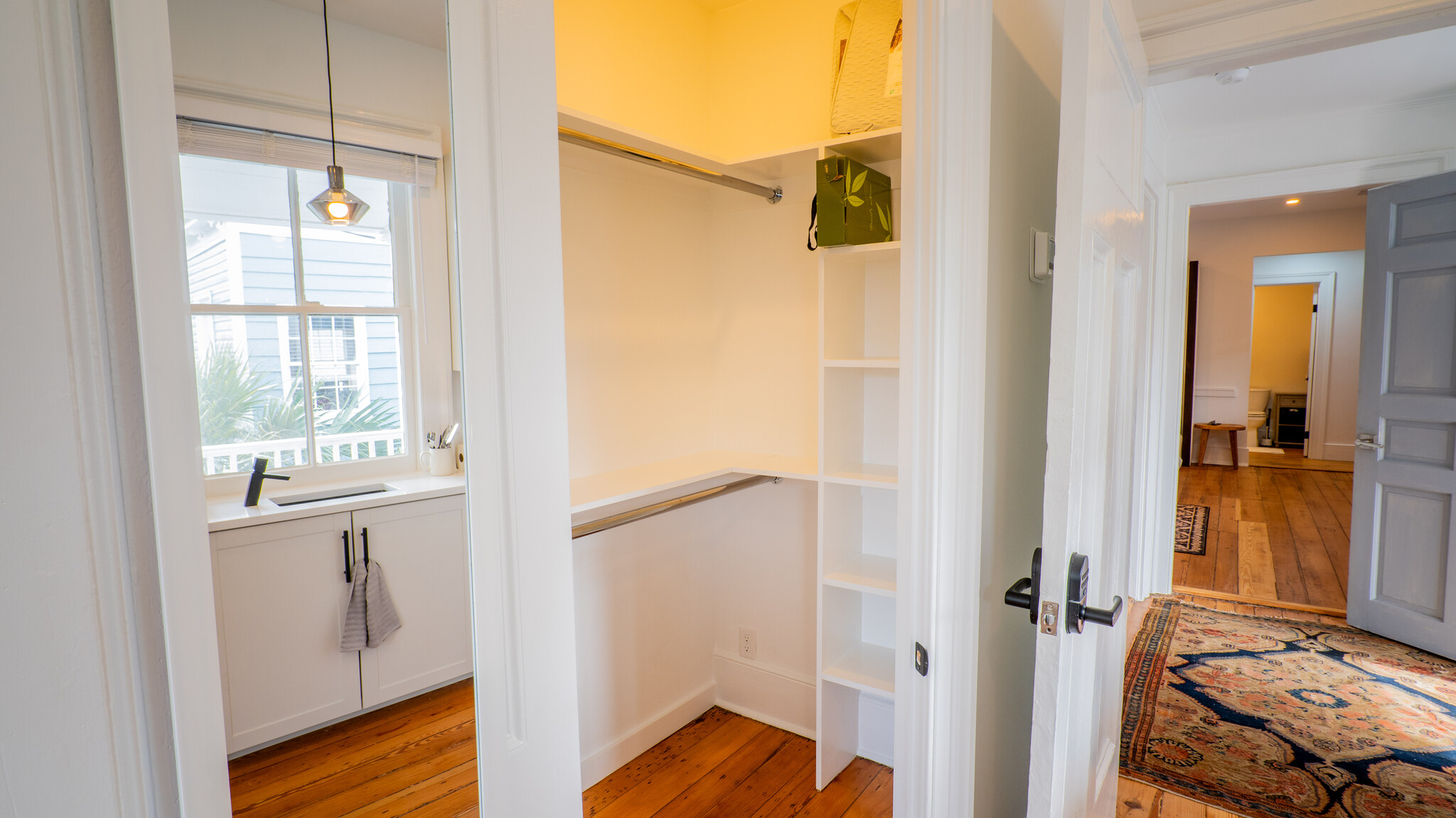 Walk-in closet with storage and mirrored door. - 208 Ashley Ave