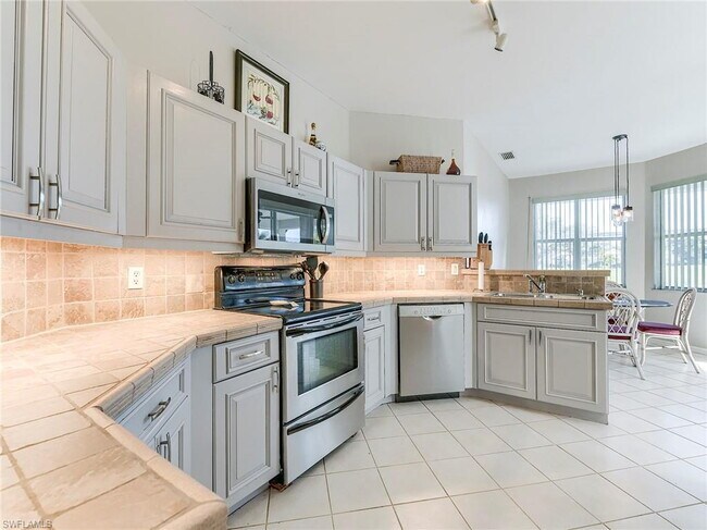 Building Photo - Turnkey 2-bedroom plus den villa, perfectly situated to capture stunning golf course and lake vie...