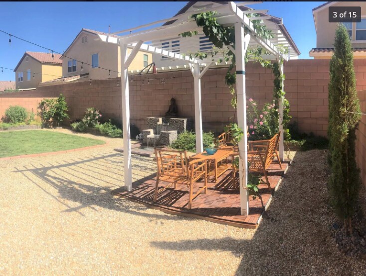 Backyard has pergola with grape vines, water fountain, a real grass area and surrounding plants and trees, relaxing. Not including furniture - 263 Garden Trellis Ct