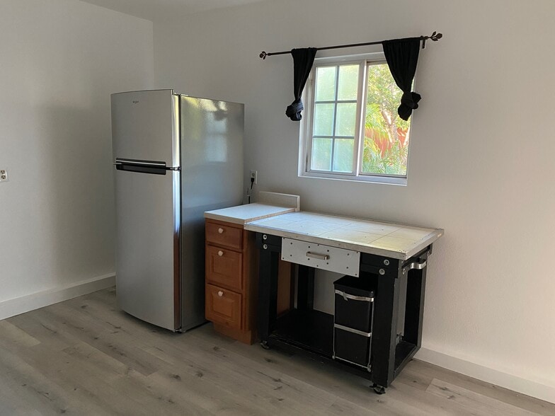 Fridge and window that overlooks patio with fruit trees - 5029 Douglas Ln