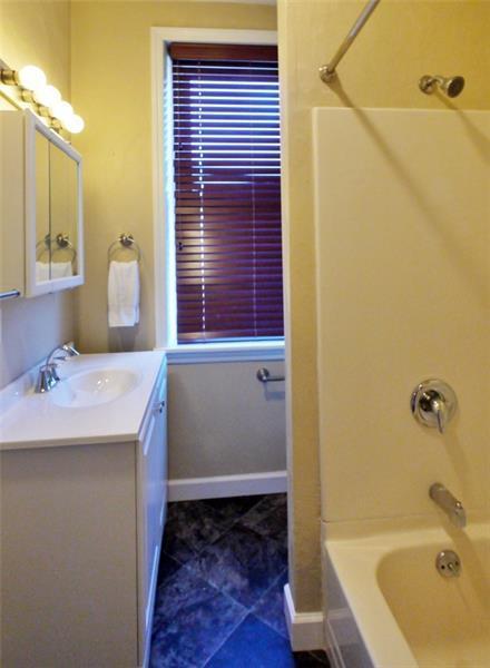 The bathroom has been recently updated with a new vanity and flooring. - 1109 Haslage Ave