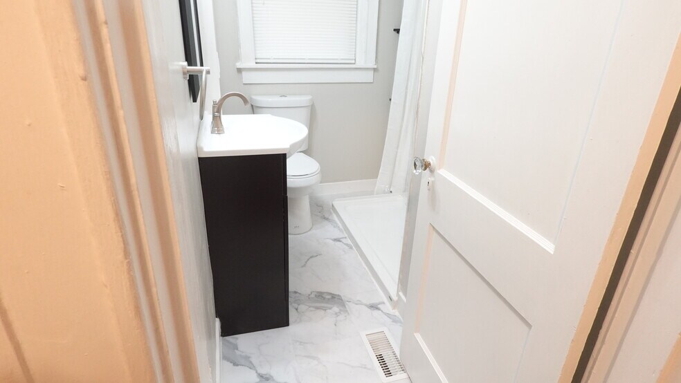 Brand new updated bathroom, with vanity storage as well as corner storage near beautiful new flexsto - 4967 Lindenwood Ave