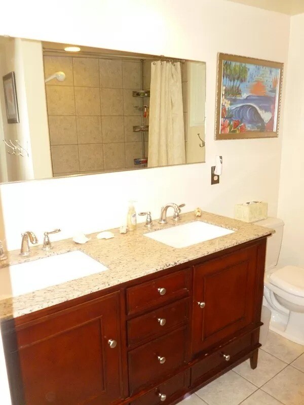 Full bathroom upstairs with double sink and bathtub. - 1705 NE Lower Dr