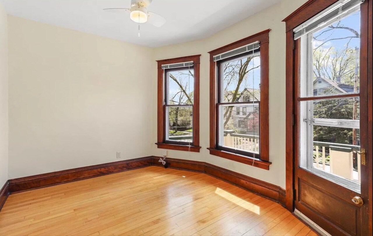 Bedroom facing street with door to front porch. - 707 S Dickinson St