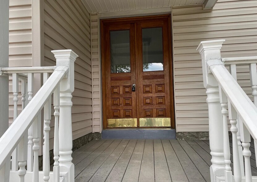 Welcoming front entrance featuring beautiful solid wood double doors and a covered porch. - 453 Lancaster Ave
