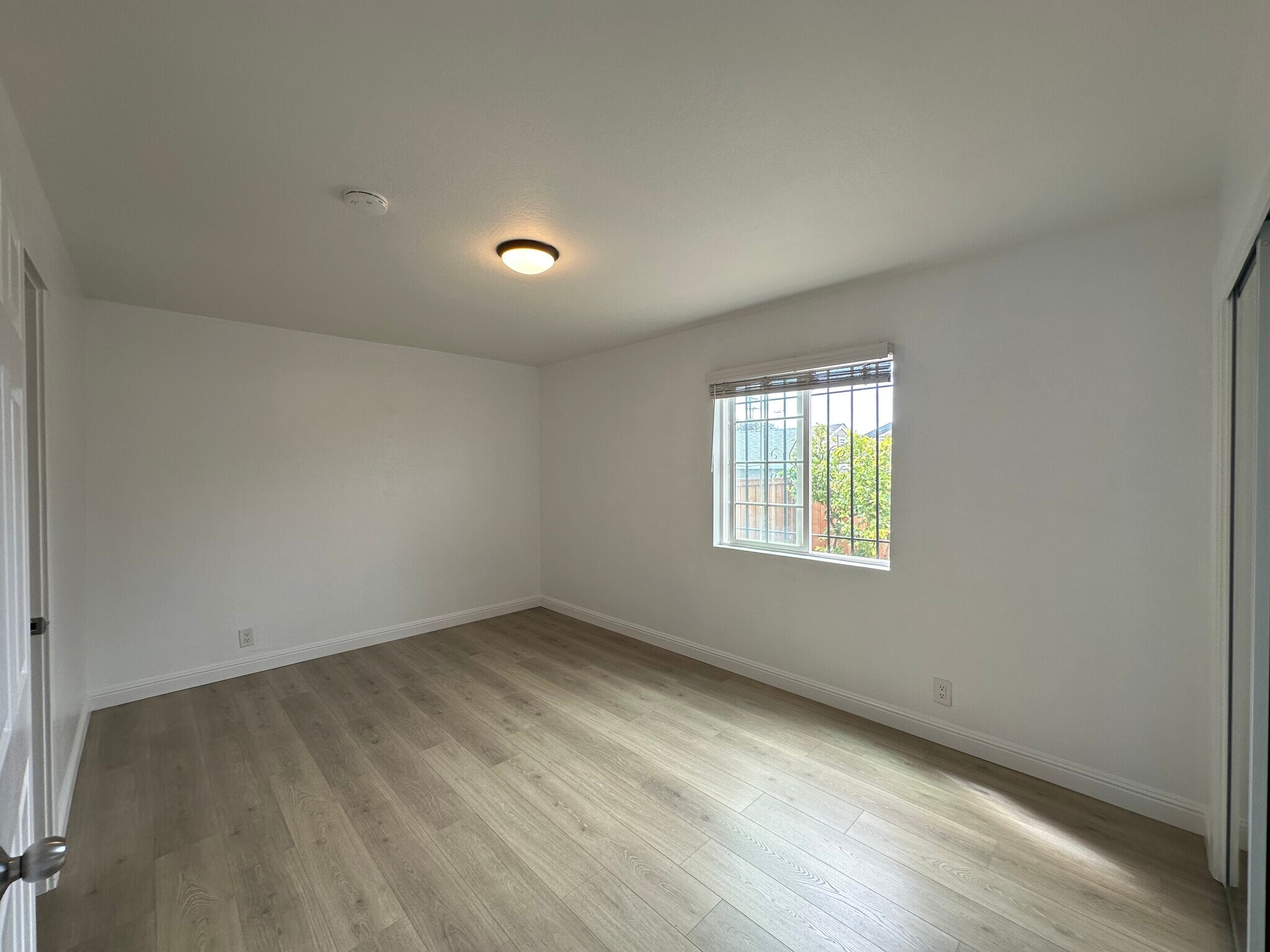 Cozy primary bedroom with natural light and fresh paint. - 721 15th St