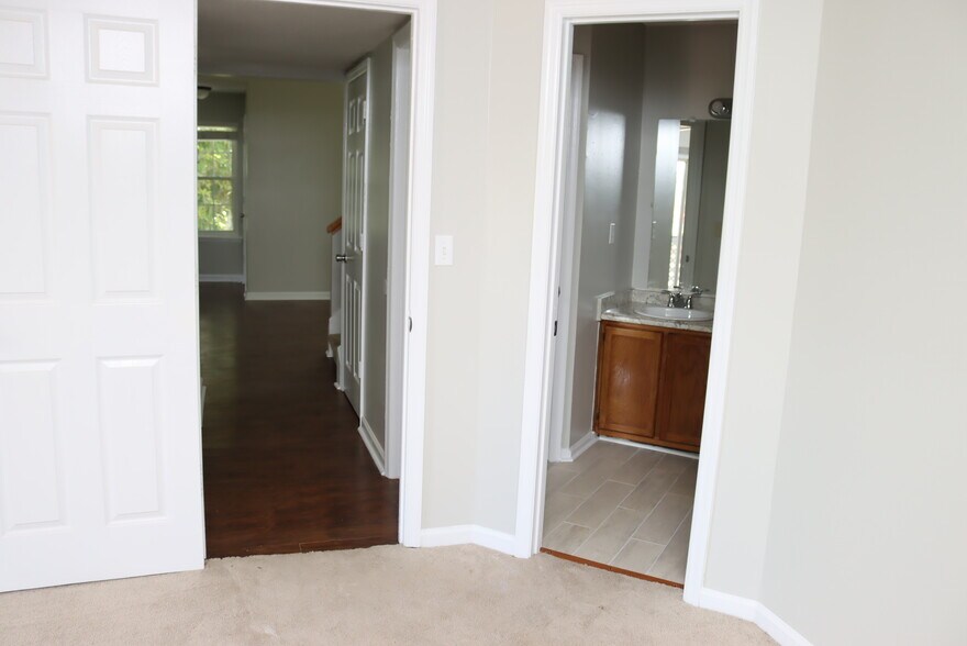 Downstairs Bedroom - Looking into Hallway and Bathroom ( right ) - 1057 Stones Throw Dr NW