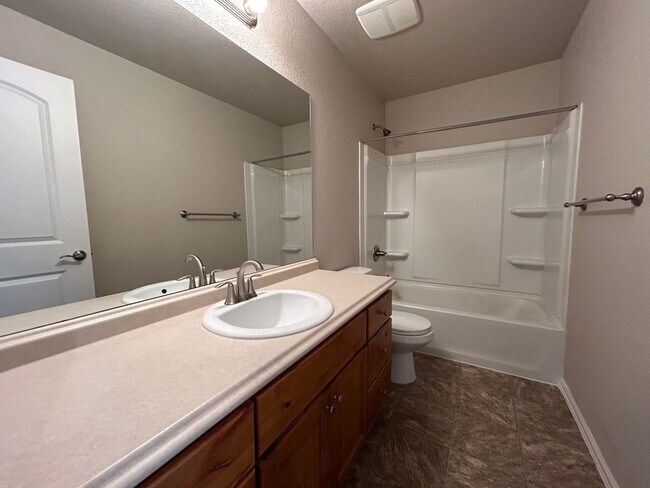 Building Photo - $500 Off First Month Of Rent! Modern 3BR Townhome with Fenced Yard & Garage