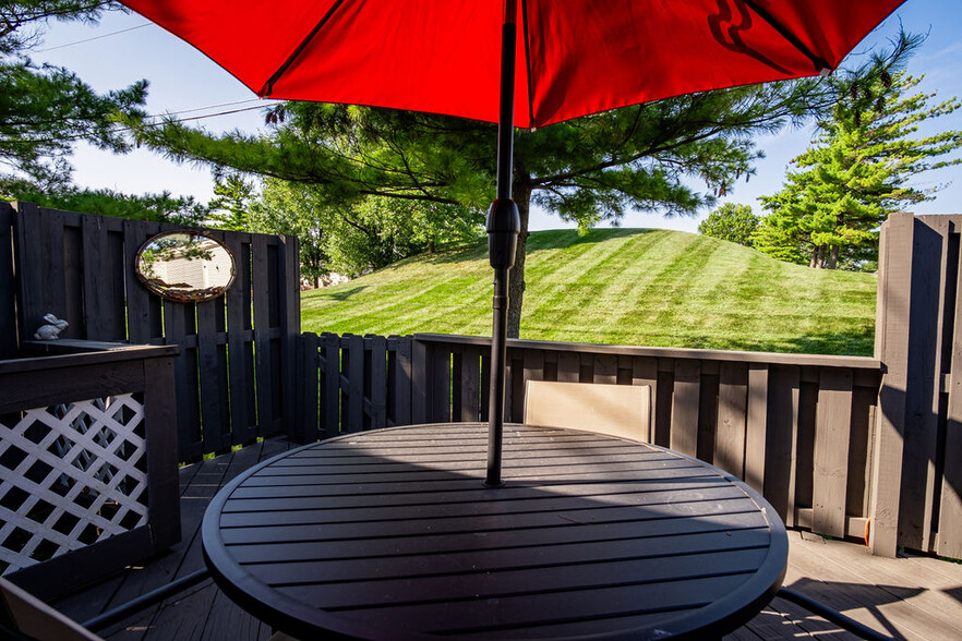 Deck with Patio Table and chairs and view of Greenspace - 740 Timber Way Dr