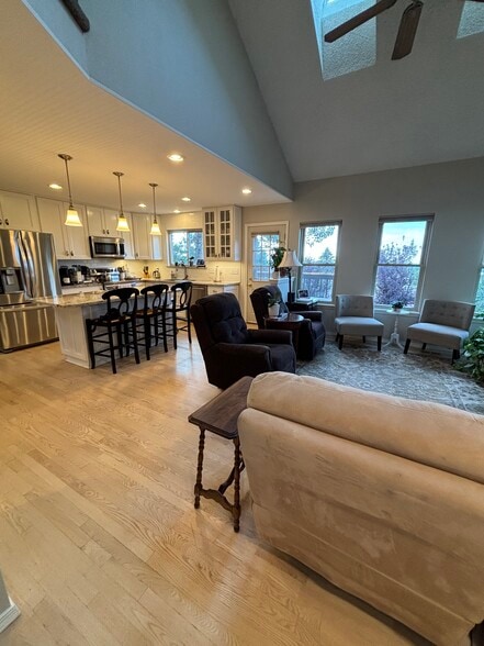 Kitchen opens to family room with front range , city and likes peak views - 3425 Birnamwood Dr