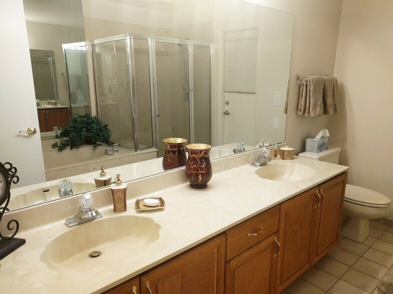 Master bath has dual sink vanity, full size soaking tub, and glass shower. - 2662 NW 42nd St