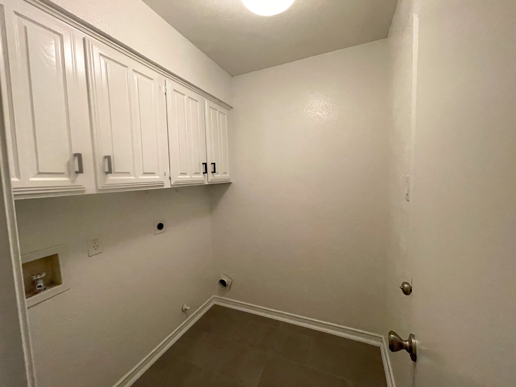 Full size washer dry laundry room just off the kitchen with additional storage space. - 812 Via Madonna