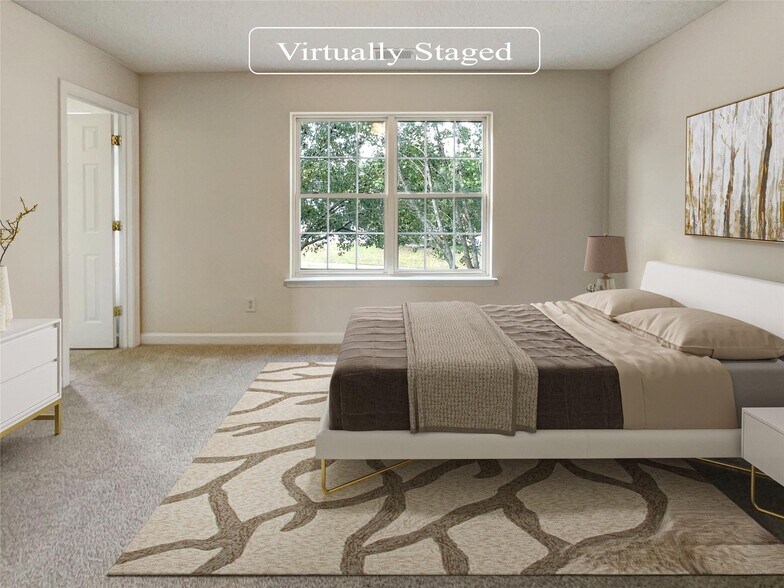 Primary bedroom is spacious enough for a king bed set. - 6903 Seney Dr