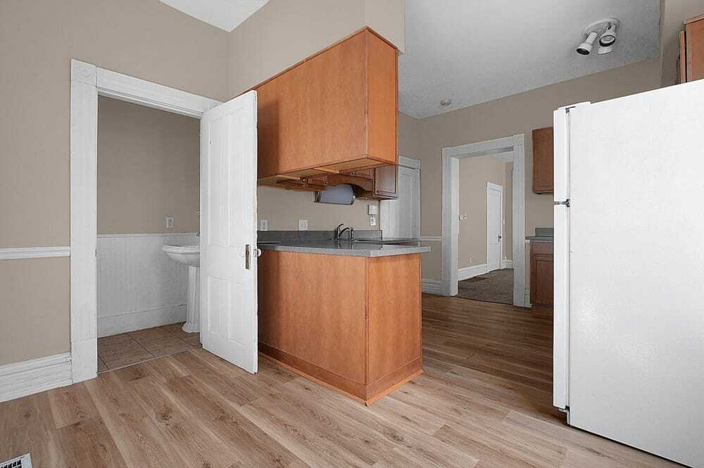 Kitche and half bath with dining room in background - 328 W 1st Ave