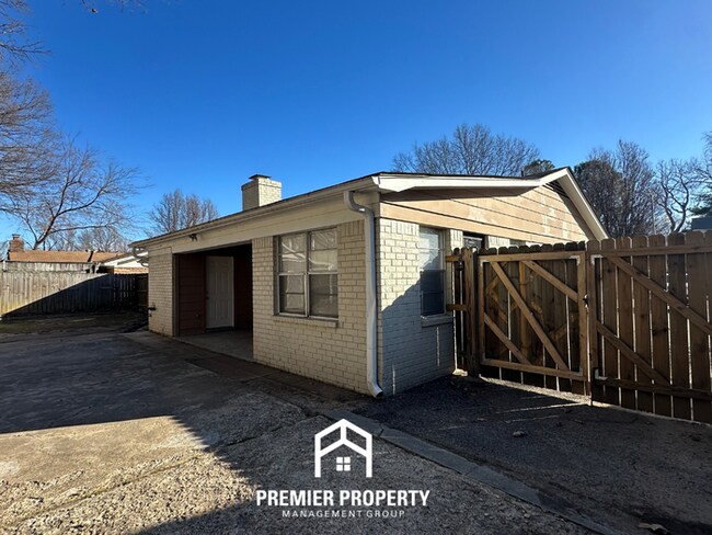 Building Photo - Charming 3BR Memphis Home | Rustic Brick Fireplace, Formal Dining & Fenced Backyard