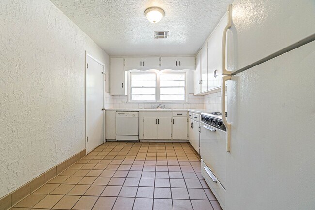 Building Photo - Three Bedroom Home in tree filled neighborhood! Lawn care included!