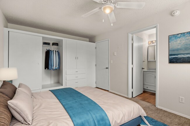 Cozy and functional bedroom, virtually staged to highlight built-in storage, soft carpeting, and a clean, modern design. - Highland Court Apartments