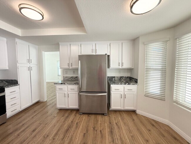 Building Photo - Corner Lot Beauty with Open Living, Guest Suite Down & Expansive Backyard