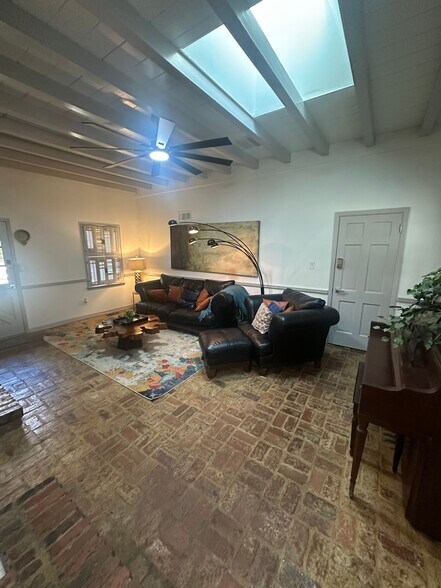 Brick walls, brick floors, big screen — a space built for comfort and character. - 5460 Scofield Rd