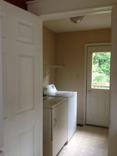 Kitchen looking into laundry room. Back door to rear deck and fenced yard. - 212 E Vermilya Ave