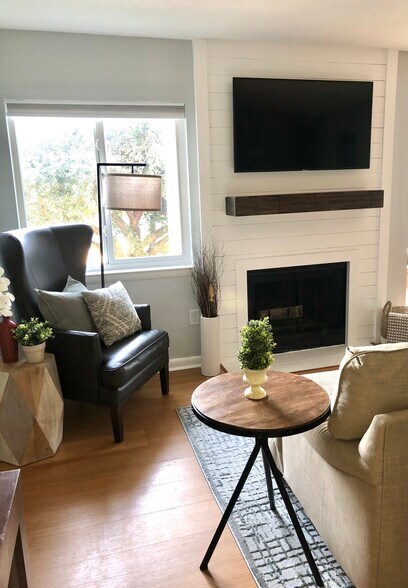 living room with updated fireplace w/ shelf & mounted TV - 264 Alexandra Dr