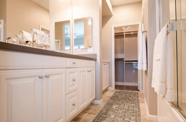 Master bath features dual counter-height vanities, a soaking tub and a walk-in shower - 5429 Strand