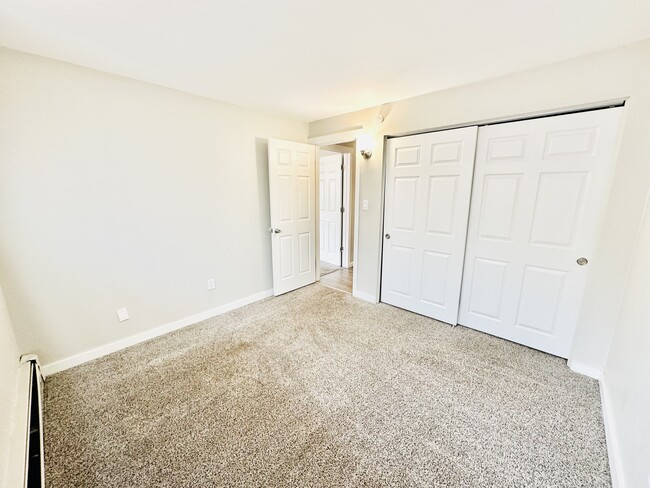 Step into this bright and airy bedroom, designed for relaxation and comfort. - Hawk Point Apartments