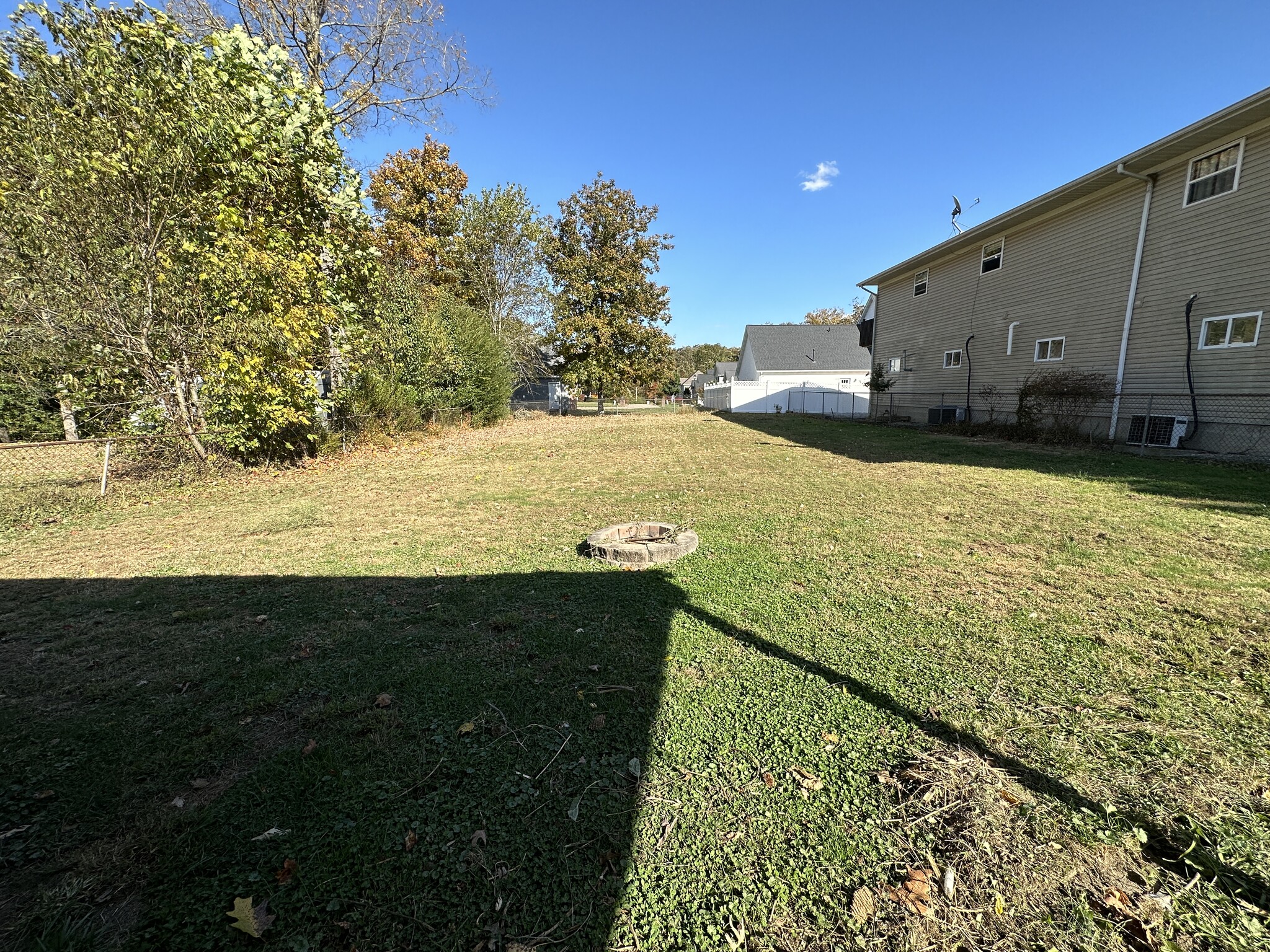 Large fenced in yard with firepit - 6120 Pinedale Dr