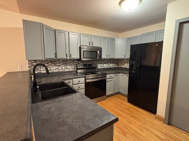 Building Photo - Spacious 3BR/3BA Condo with Finished Basement + 2-Car Garage — Available Now