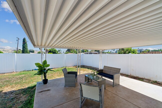 Enjoy the backyard patio, a great space for outdoor dining. - 9853 Saint George St