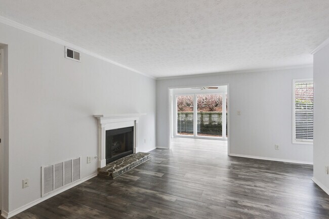 Living area view to sunroom and fireplace - 1203 Vicksburg Pl