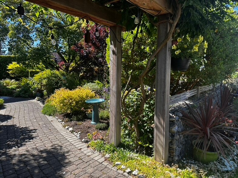 A welcoming entrance through beautiful English-inspired gardens. - 11639 1st Ave NW
