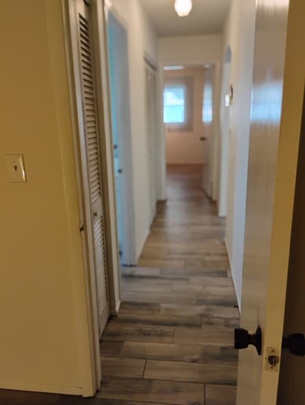 Hallway between bedrooms, bathroom is on left living/dining area to right - 2831 Swifton Dr