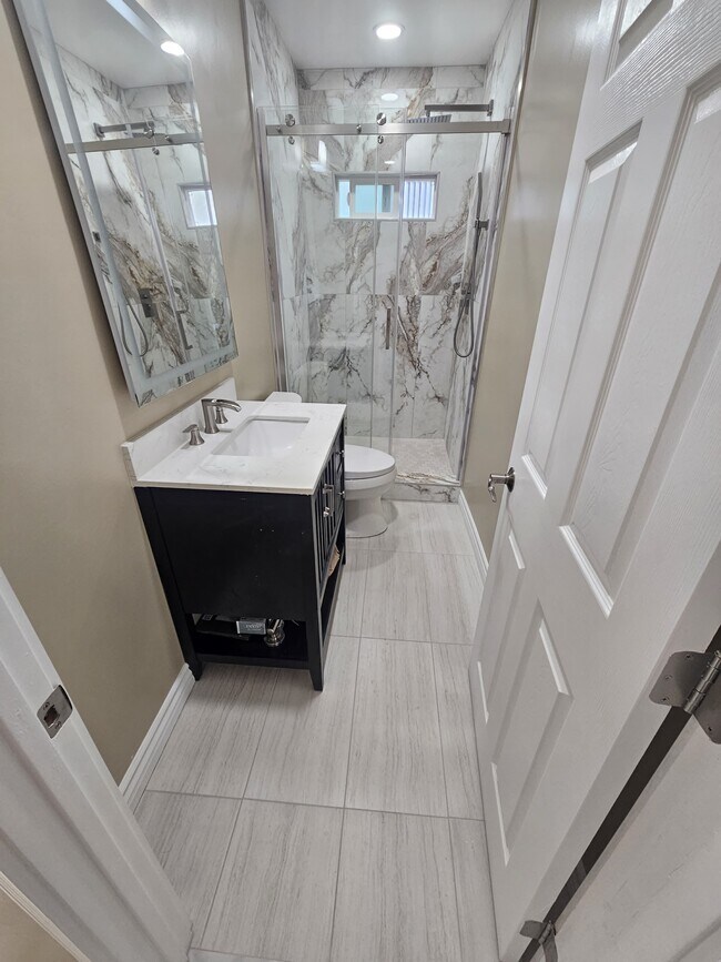Two bathrooms with walk in shower, matching looks. - 918 E Elk Ave