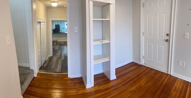 front door with bookcase/ hallway leads down to kitchen - 106 S 3rd St